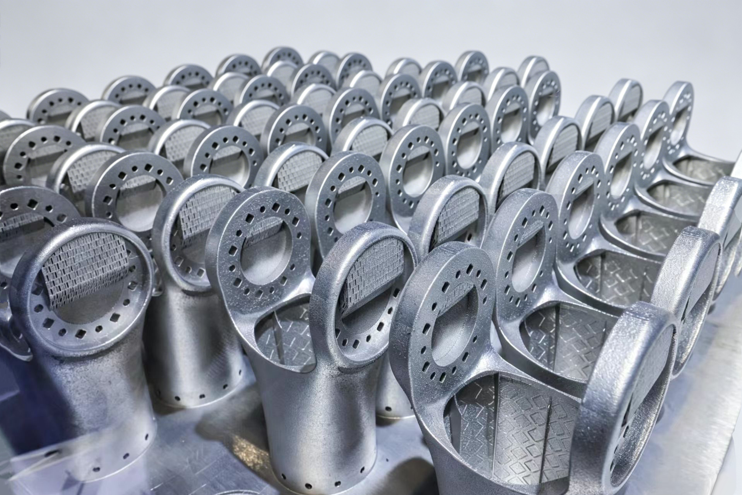 Metal AM Y-flange robot joints nested in a batch still on the build plate
