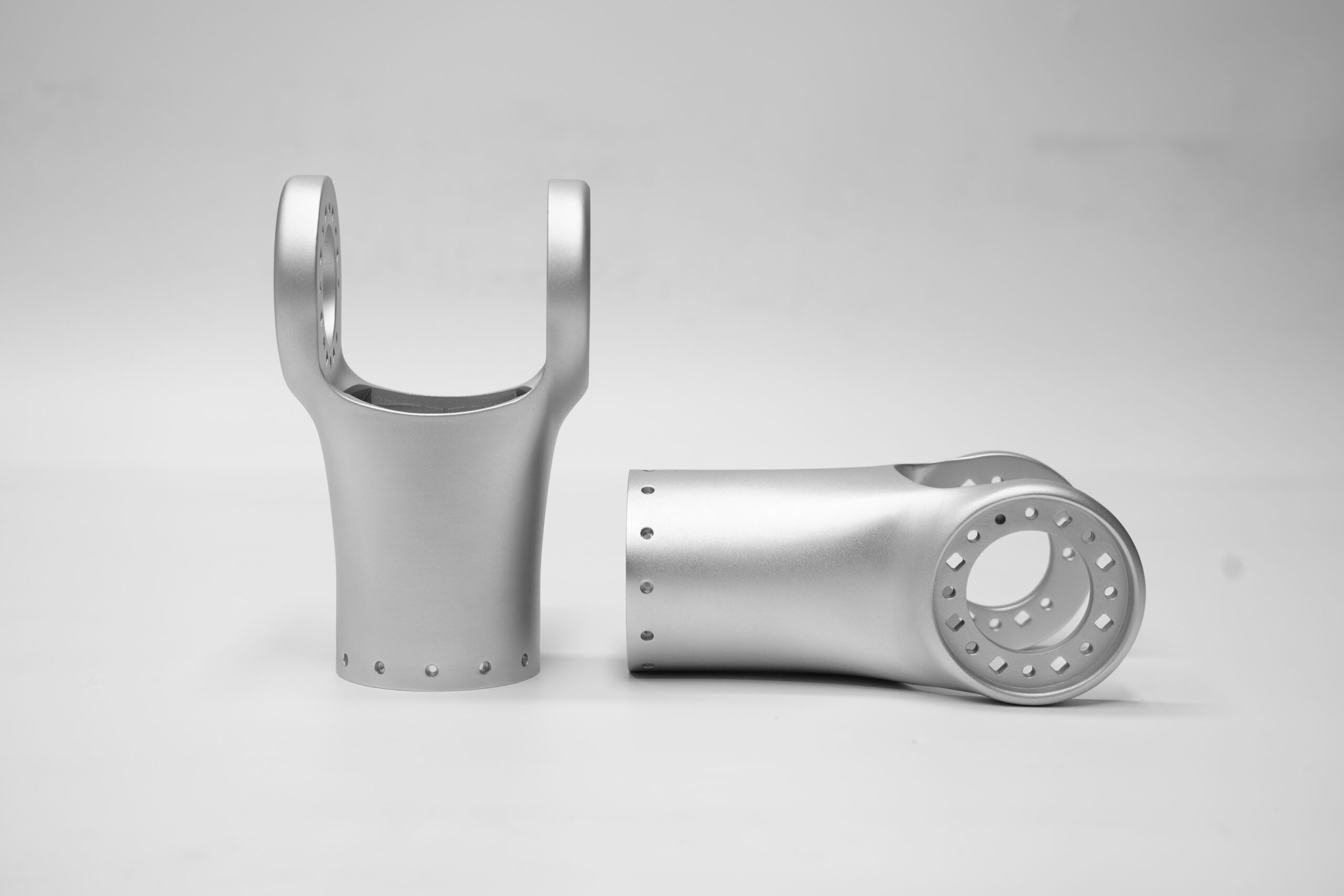 Pair of metal additive robot bifurcated Y-flange joints in upright and profile views
