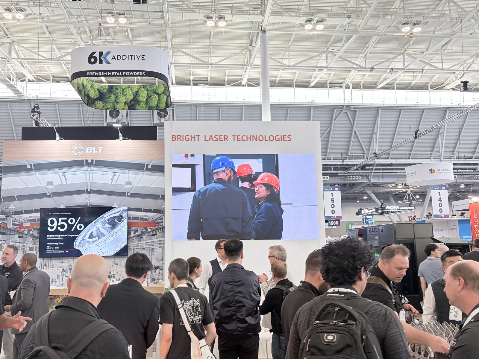 Crowded tradeshow booth with Bright Laser Technologies fascia and attendees